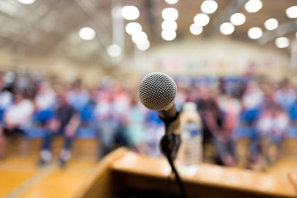 a picture of a microphone in front of a crowd