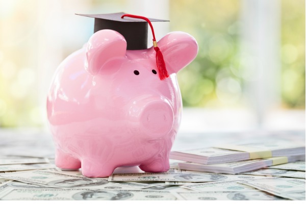a piggy bank in a graduation cap surrounded by money
