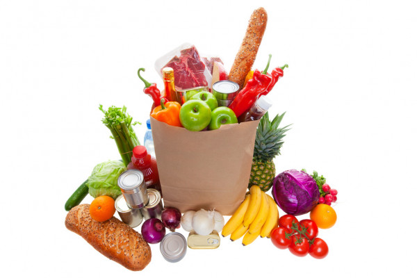 a bag of groceries with other fruits and veggies surrounding it