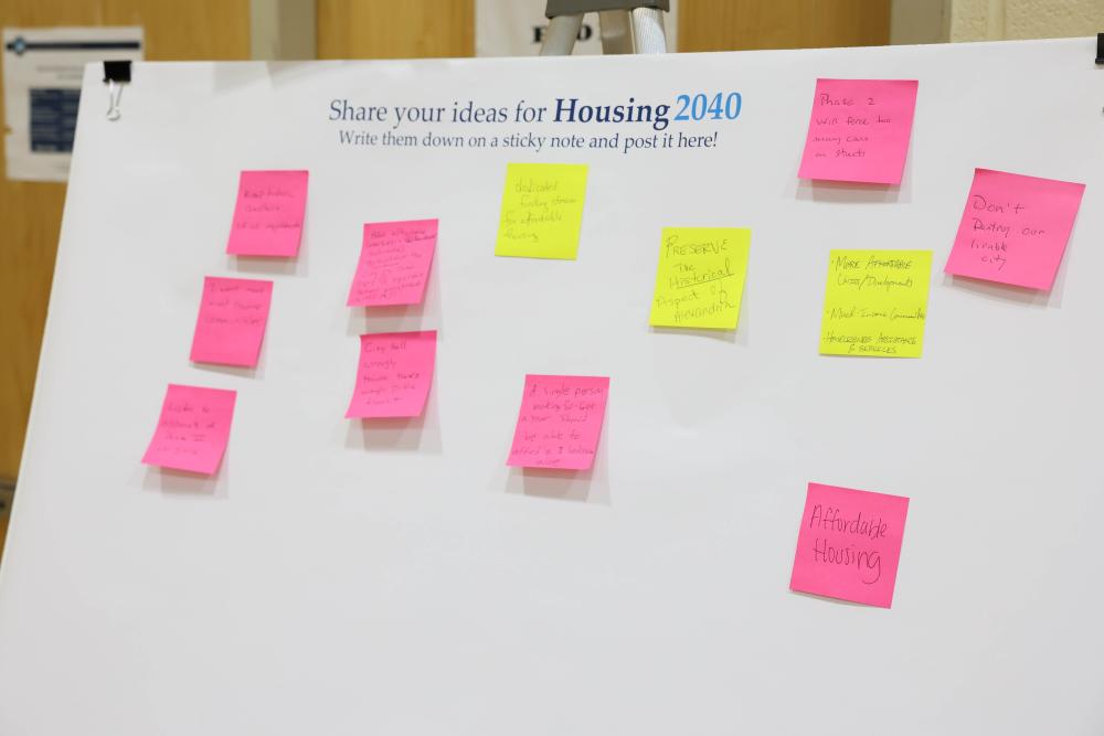 white poster board with pink and yellow sticky notes